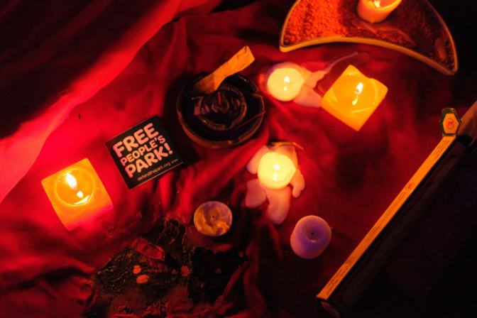 Free the Park sticker surrounded by candles and altar